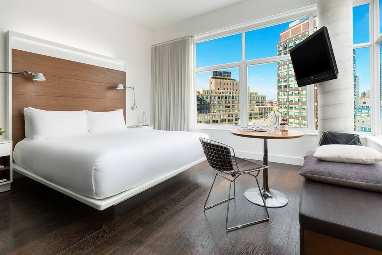 Wraparound windows offer panoramic views of lower Manhattan from this hotel room at the 27 Grand Street Hotel.