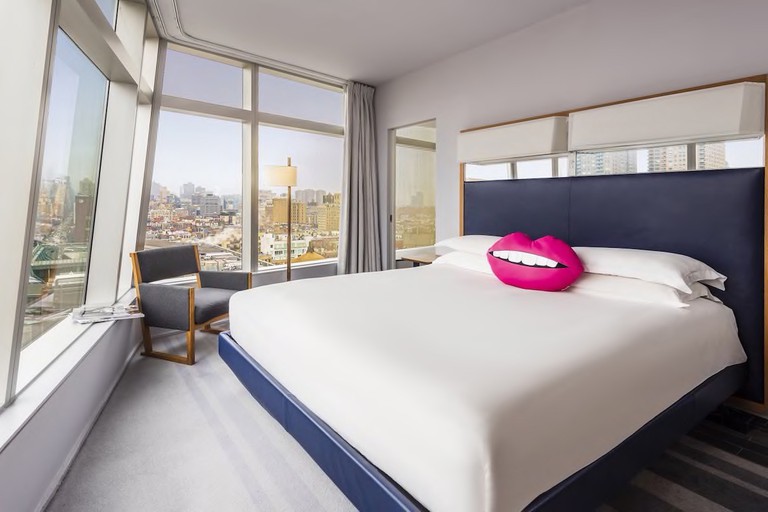 Wraparound windows offer panoramic views of lower Manhattan from this hotel room at The Standard, East Village.